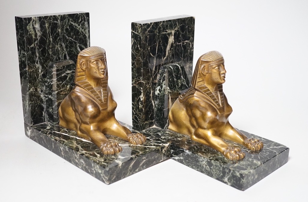 A pair of Art Deco bronze and serpentine 'sphinx' bookends, 17cms wide x 15.5cms high